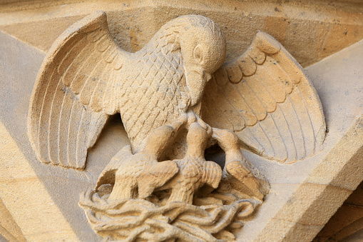 Europe. France. Moselle. Lorraine. Metz. 05/29/2014. This colorful image depicts symbolic representation. The Pelican feeding its young. Portal of the Virgin. 13th century. Gothic architecture. St. Stephen of Metz Cathedral.