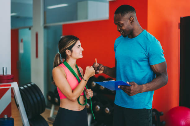 istock Sports training in the gym with personal trainer 1263173119