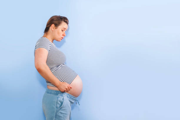 istock Pregnant woman on a blue background 1263177409