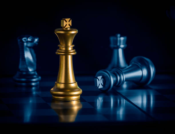 istock Golden king chess is surrounded by falling around silver chess pieces  to fighting with teamwork to victory, business strategy concept and leader and teamwork concept for success. 1263202886