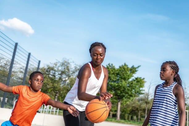 istock mother playing basketball with son and daughter 1263205468