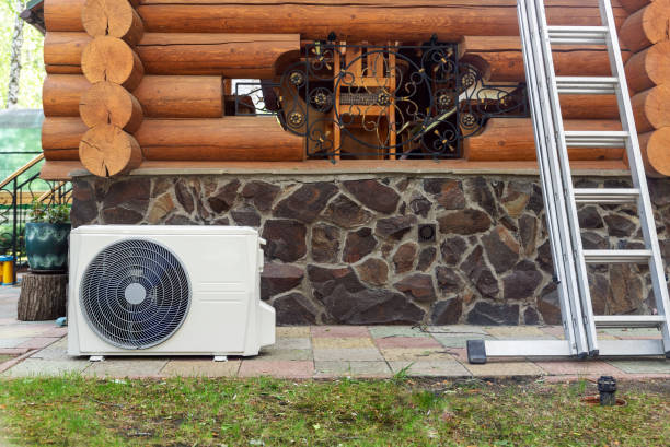 istock New modern HVAC air conditioning external compressor unit preapred for installation or replacement near wall of wooden log residential country cottage. Ladder and equipment for service and maintenance 1263213245