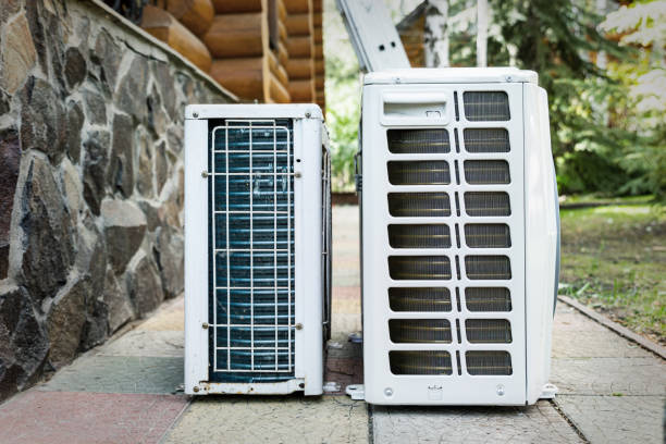 istock New modern HVAC air conditioning external compressor unit preapred for installation or replacement near wall of wooden log residential country cottage. Ladder and equipment for service and maintenance 1263213246