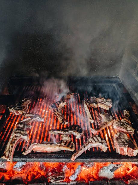 istock Grilled lamb ribs. Large metal grate with hot coals. 1263226428