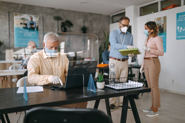 istock Coworkers working with protective face masks at bank 1263232165