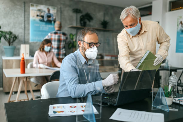 istock Coworkers working with protective face masks at bank 1263232738