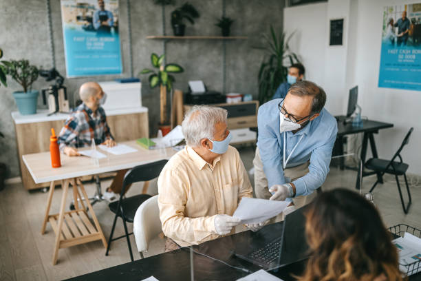 istock Coworkers working with protective face masks at bank 1263232807