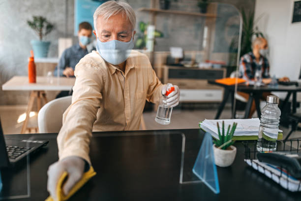 istock Senior businessman disinfecting at office 1263233037