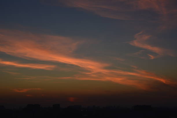 istock Sunset golden sky with thin clouds, horizontal zigzag lines across heaven 1263233757