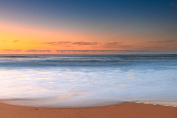 Winter's morning by the sea with waves and minimal soft light cloud at Killcare Beach on the Central Coast, NSW, Australia.