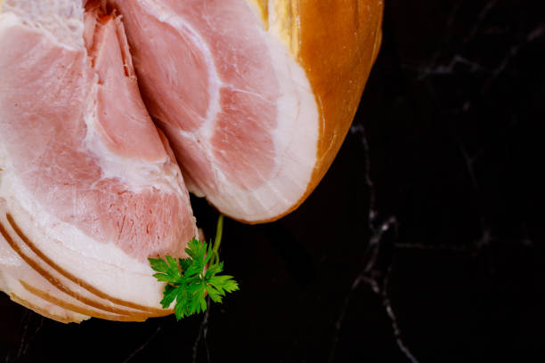 istock Whole sliced ham with fat on black background.. 1263242043