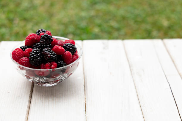 Fruits on a wooden table on a background of green grass