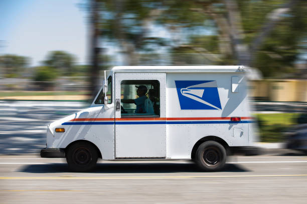 USPS Fullerton, California / USA - July 18, 2020: A USPS (United States Parcel Service) mail truck leaves for a delivery. united states postal service photos stock pictures, royalty-free photos & images