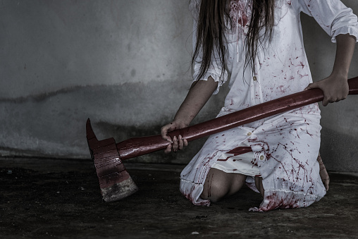Zombie or Ghost woman with bloody holding axe in dark room house ,halloween concept