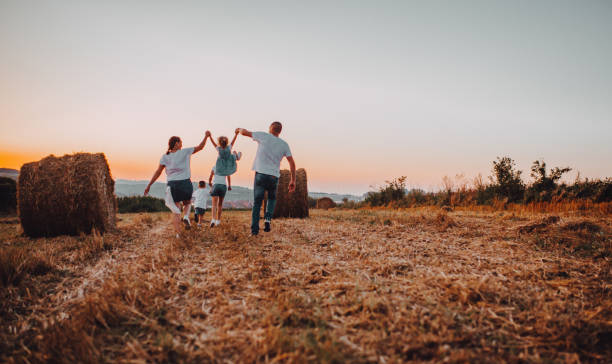 istock Family jump at sunset 1263250238
