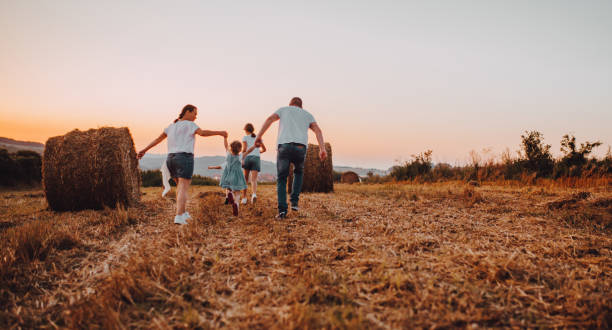 istock Family jump at sunset 1263250294