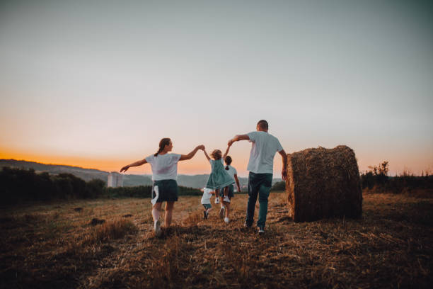 istock Happy farmer family and sunset 1263250364