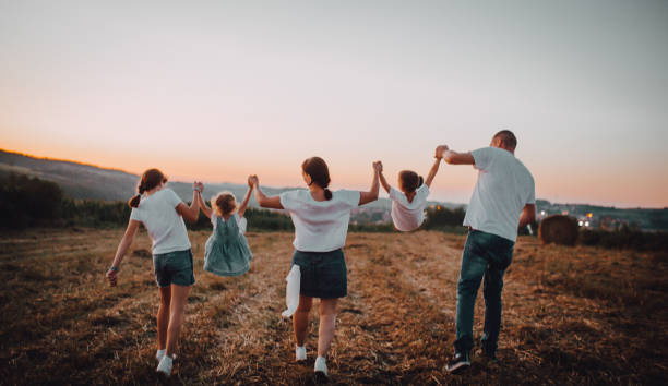 istock Family jump at sunset 1263250877