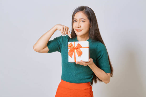 istock Asian woman holding christmas gift 1263250894