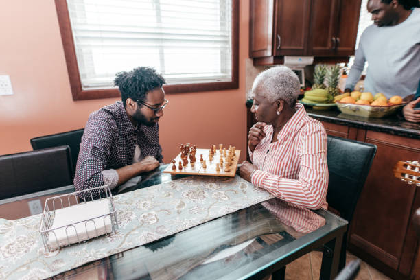istock Senior woman playing chess with grandson 1263252791