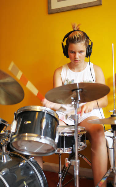 istock Caucasian girl playing drums at home. 1263258571