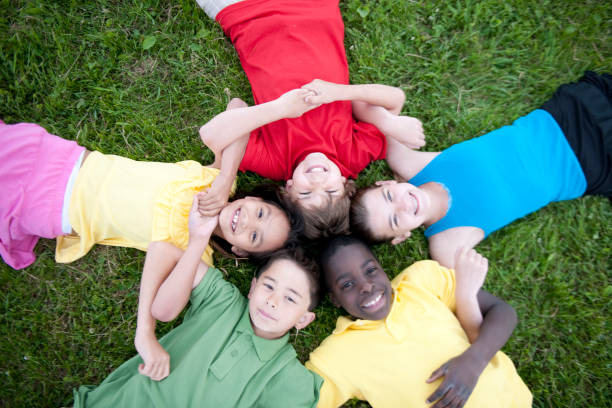 istock Kids playing together on a grass hill 1263261926