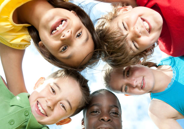 istock Kids playing together on a grass hill 1263261931