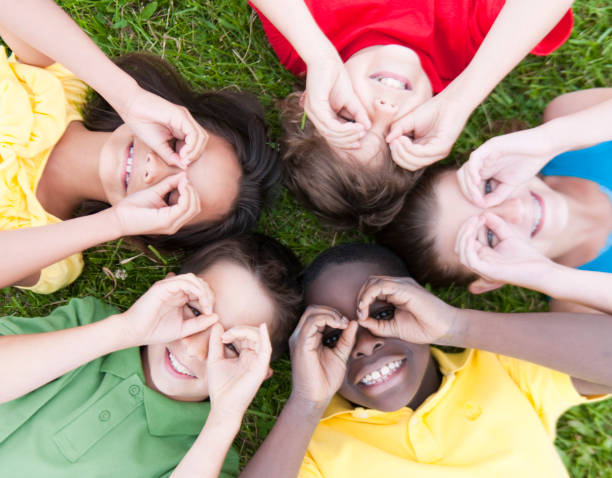 istock Kids playing together on a grass hill 1263261932