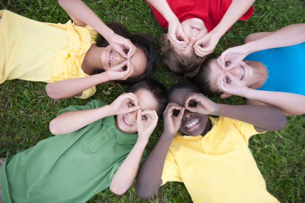 istock Kids playing together on a grass hill 1263261938