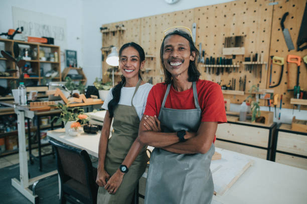 istock Carpenter smiling and embracing partner at workshop 1263266248