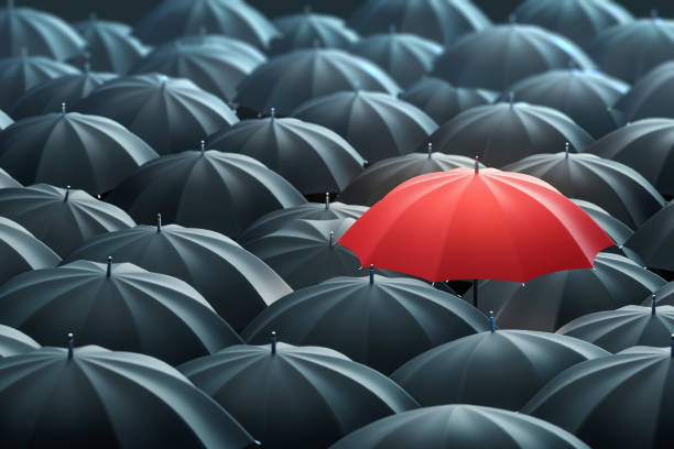 istock Red Colored Umbrella Between The Black Umbrellas 1263278089