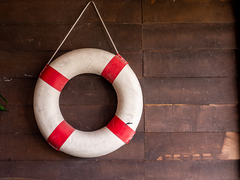 Sea lifebuoy on wooden background . Copy space for individual text. Summer Banner.
