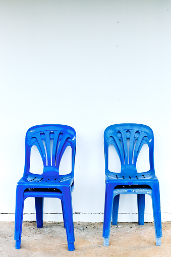 Old and dirty blue plastic chairs