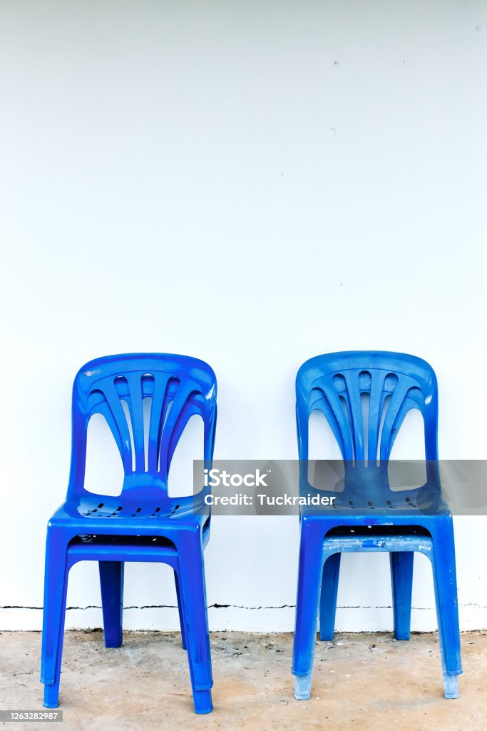 Old and dirty blue plastic chairs Blue Stock Photo