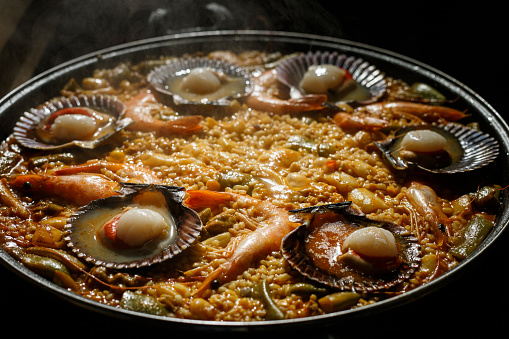 Traditional Spanish paella with seafood with mussels and shrimps in a frying pan
