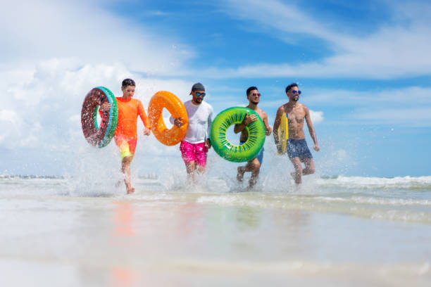 istock Running with inflatable ring tubes on a beach in Miami 1263285565