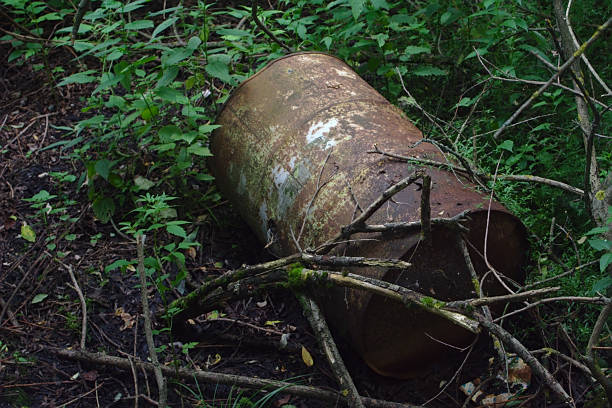 istock a rusty iron barrel is lying in a landfill 1263300790