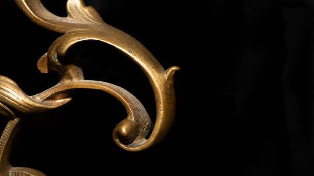 istock Antique abstract backdrop. Bronze curved metal decor on cracked black wood. Copyspace. 1263301198