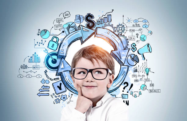 istock Thinking little boy in glasses, business plan 1263308758