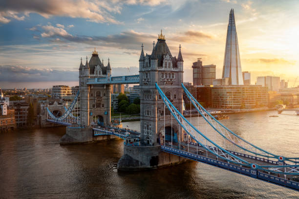 Elevated sunset view of the famous Tower Bridge and skyline of London Elevated view of the famous Tower Bridge and skyline of London, UK, during beautiful sunset time in summer drawbridge photos stock pictures, royalty-free photos & images