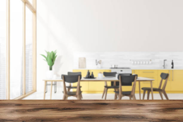 istock Table in blurry kitchen with yellow countertops 1263309013