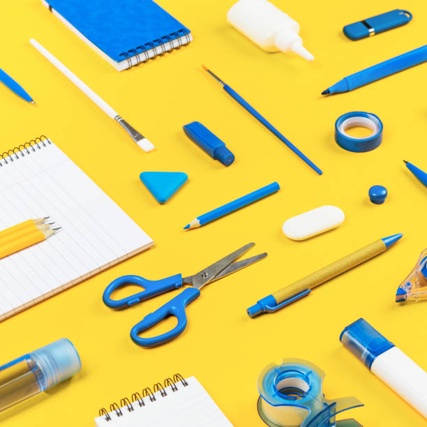 istock Assorted office and school white and blue stationery on yellow 1263312131