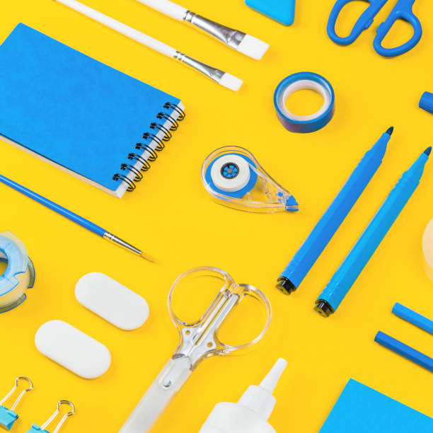 istock Assorted office and school white and blue stationery on yellow 1263312640