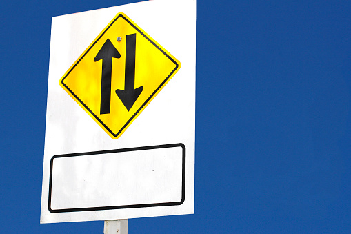 Two-way traffic sign, two-way traffic sign in tourist attraction on blue sky background