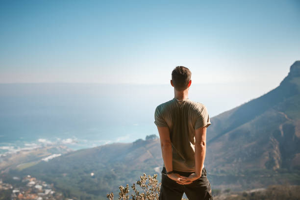 istock Man hiker stretching in the mountains with beautiful sea view 1263318961
