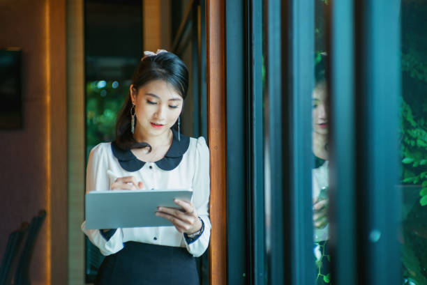 istock Woman are standing and are using a tablet. 1263321895