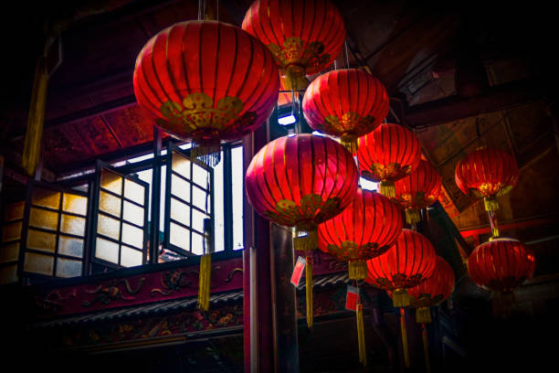 Red lanterns in an old temple with 3 vintage windows