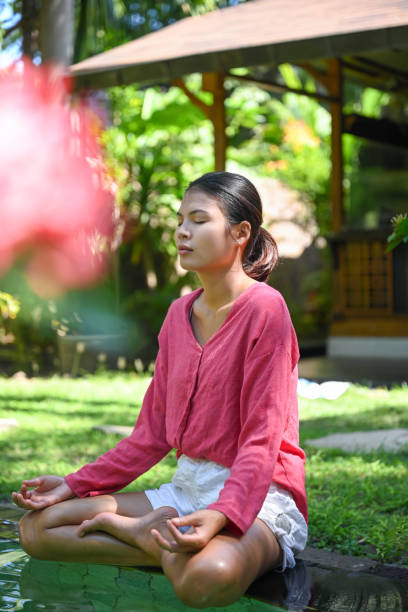 istock Woman meditates in a lotus position 1263325430