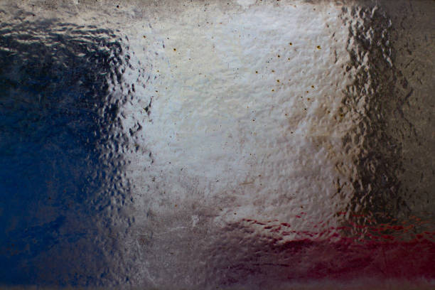 Structured glass texture background with red, white and blue colors shining through it
