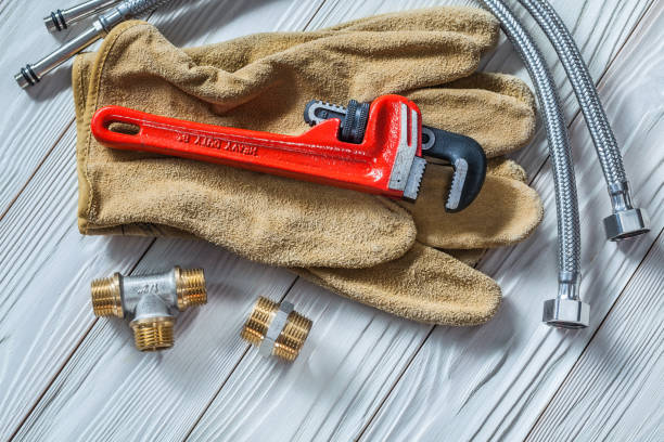 istock adjustable spanner on leather gloves pipe fixtures water hoses on white wood boards 1263336632